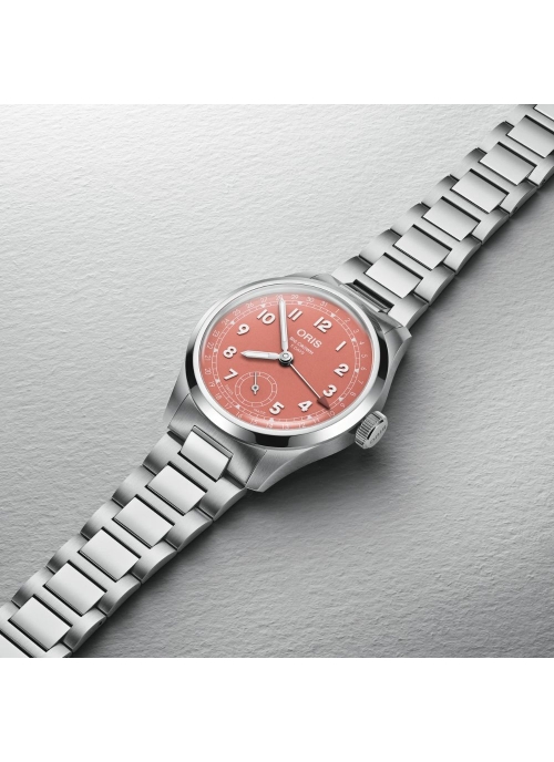 Reloj automático en caja de acero de 40mm con reserva de marcha de hasta 120h, esfera color terracota y brazalete de acero.