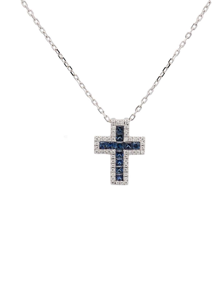 Cruz de oro blanco de 18Kt, de 12x10mm (ancho 3,60mm) con zafiros talla carré en el centro, con un peso total de 0,31ct rodeados